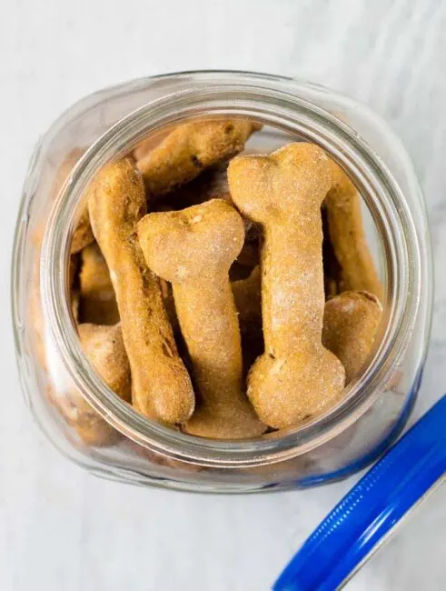 Pumpkin apple dog biscuits are a healthy, crunchy treat for your furry friend. Substitute almond flour for the wheat flour if your dog can't have grains.