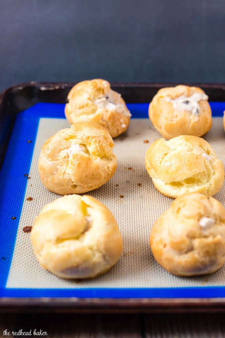 A baking sheet of cannoli cream puffs