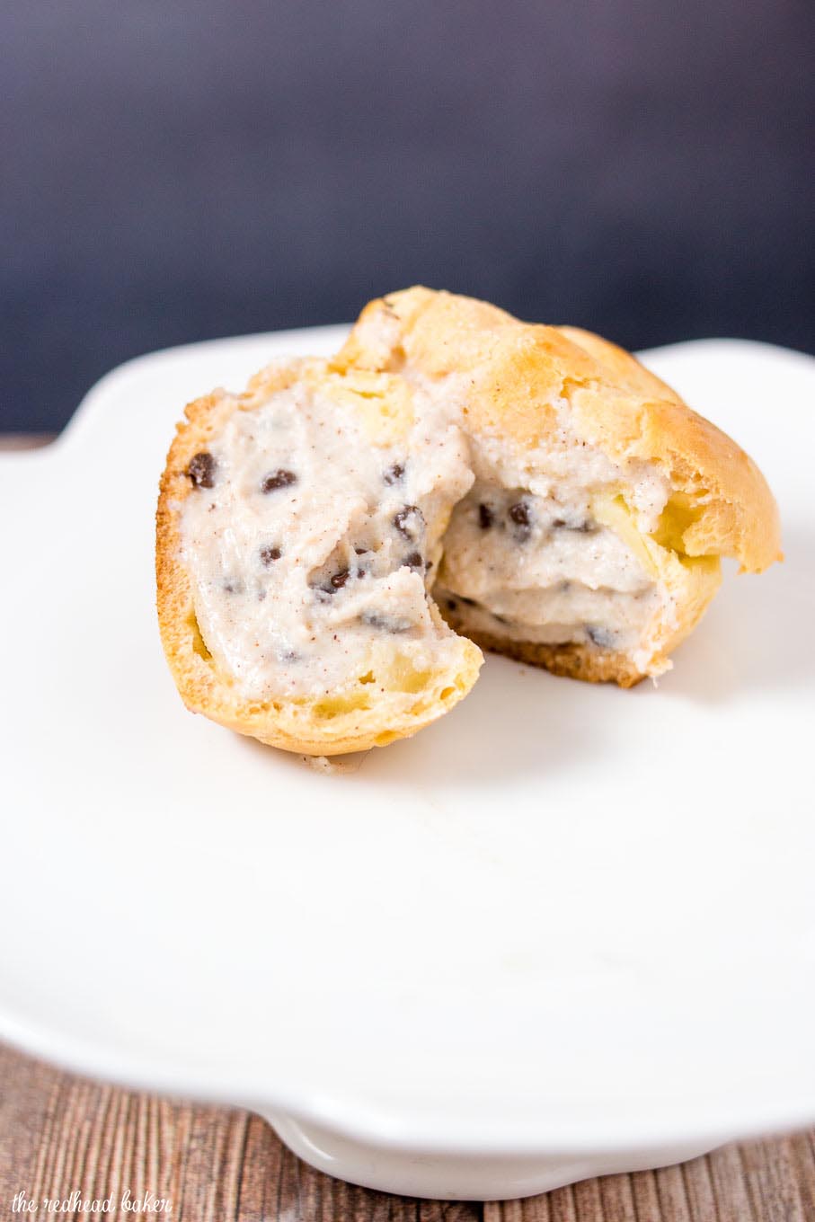 A cannoli cream puff cut in half to reveal the filling.