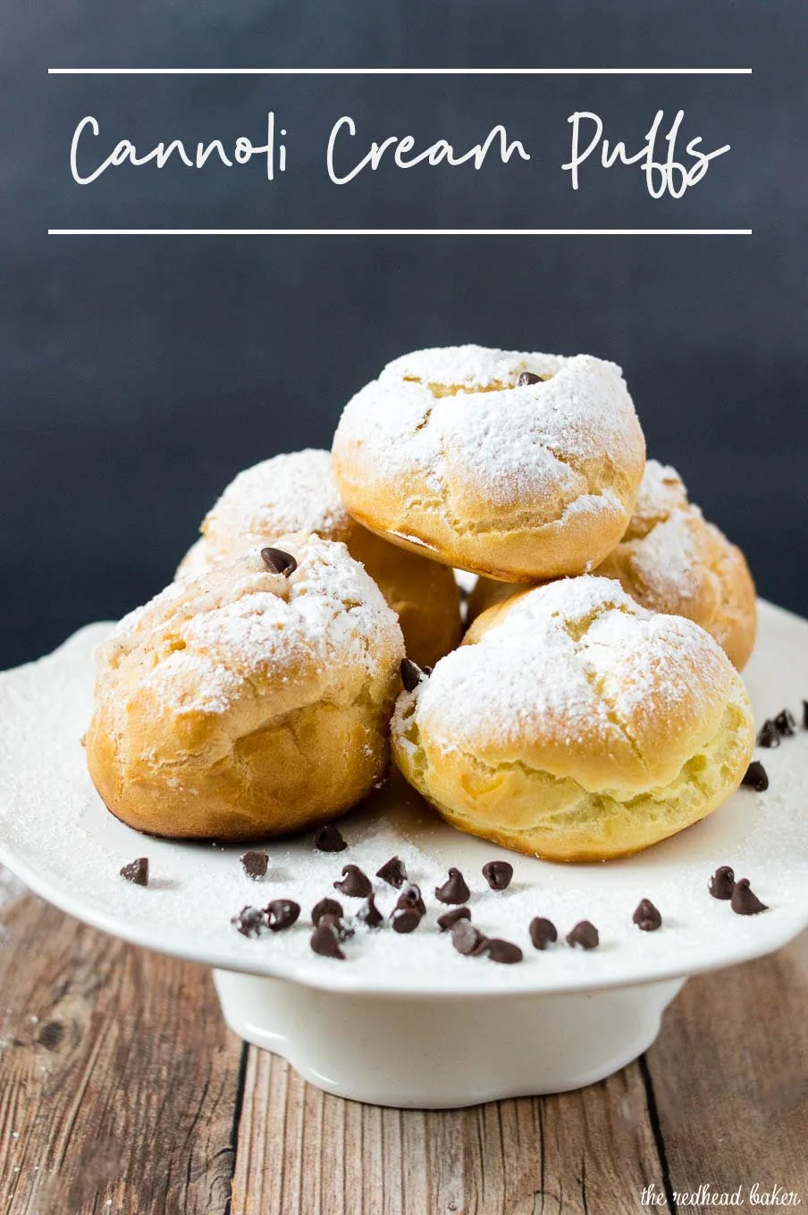 A plate of powdered-sugar-dusted cannoli cream puffs with mini chocolate chips scattered around.