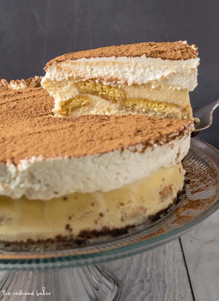 A slice of tiramisu cheesecake being lifted on a cake server.