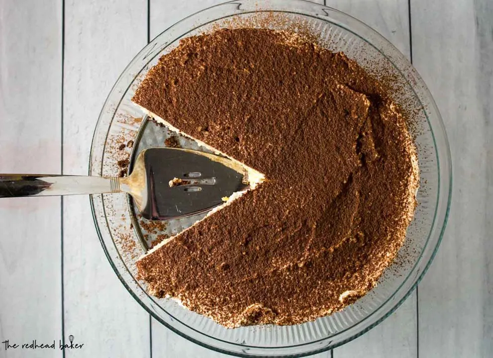 An overhead shot of a tiramisu cheesecake with two slices taken out. 