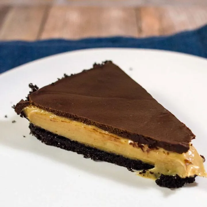 This decadent chocolate peanut butter tart has a sweet chocolate crust, a custardy peanut butter filling, and a rich chocolate glaze. It uses just a few ingredients, and requires almost no baking!