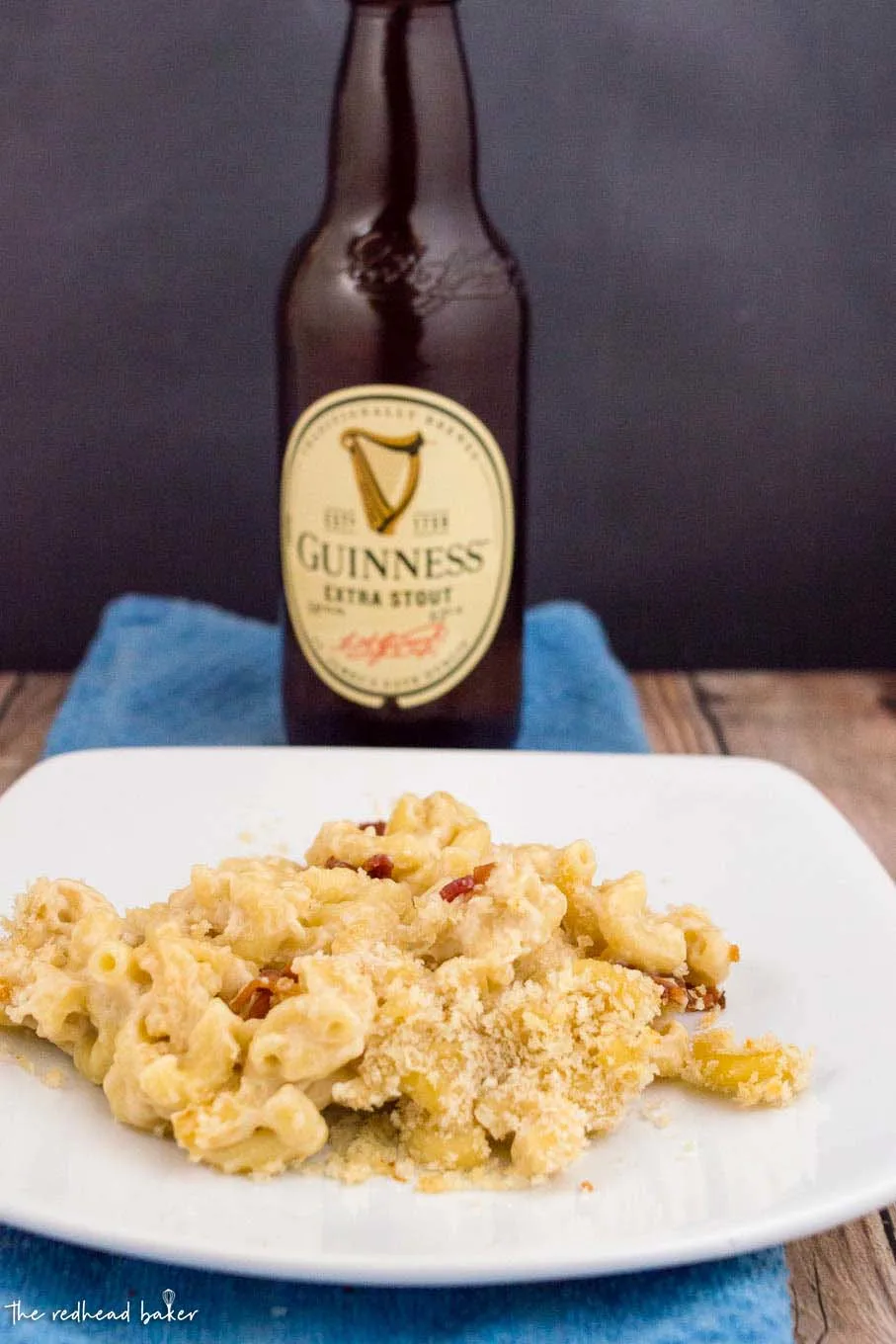 A plateful of Irish mac and cheese with a bottle of Guinness beer behind it.