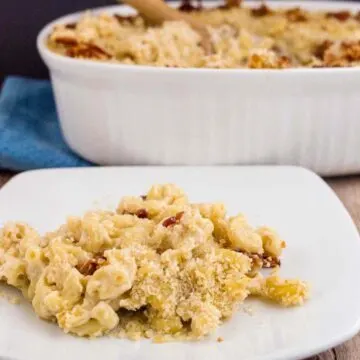 A plateful of Irish mac and cheese in front of a casserole dish.