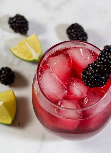 Blackberry lime margaritas have a vibrant color and delicious flavor. Adding lime zest to the simple syrup ensures that the blackberry doesn't overpower the drink's flavor.