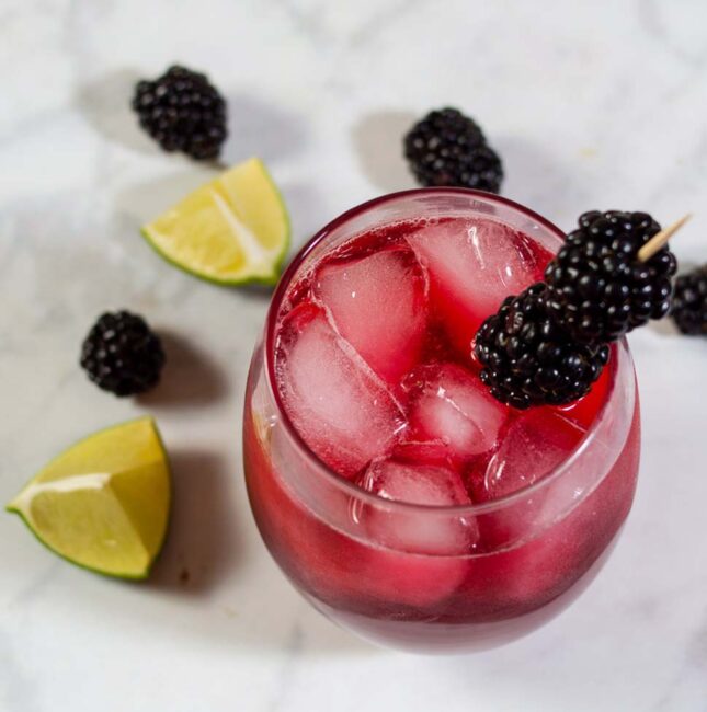 Blackberry lime margaritas have a vibrant color and delicious flavor. Adding lime zest to the simple syrup ensures that the blackberry doesn't overpower the drink's flavor. 