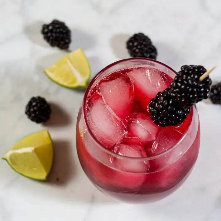 Blackberry lime margaritas have a vibrant color and delicious flavor. Adding lime zest to the simple syrup ensures that the blackberry doesn't overpower the drink's flavor. 