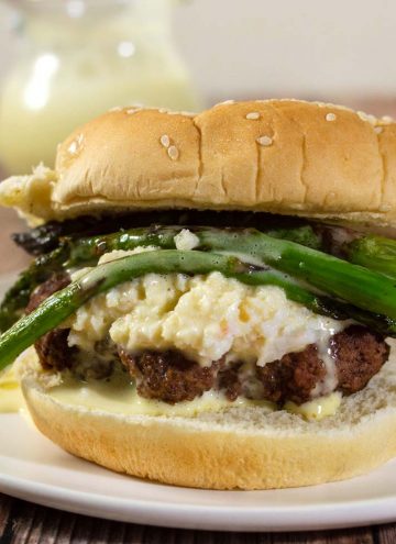 Surf-n-turf meets backyard cookout in these Oscar-Style Burgers. Hamburger patties are topped with crab meat, tender-crisp asparagus and rich Bearnaise sauce. #BurgerMonth