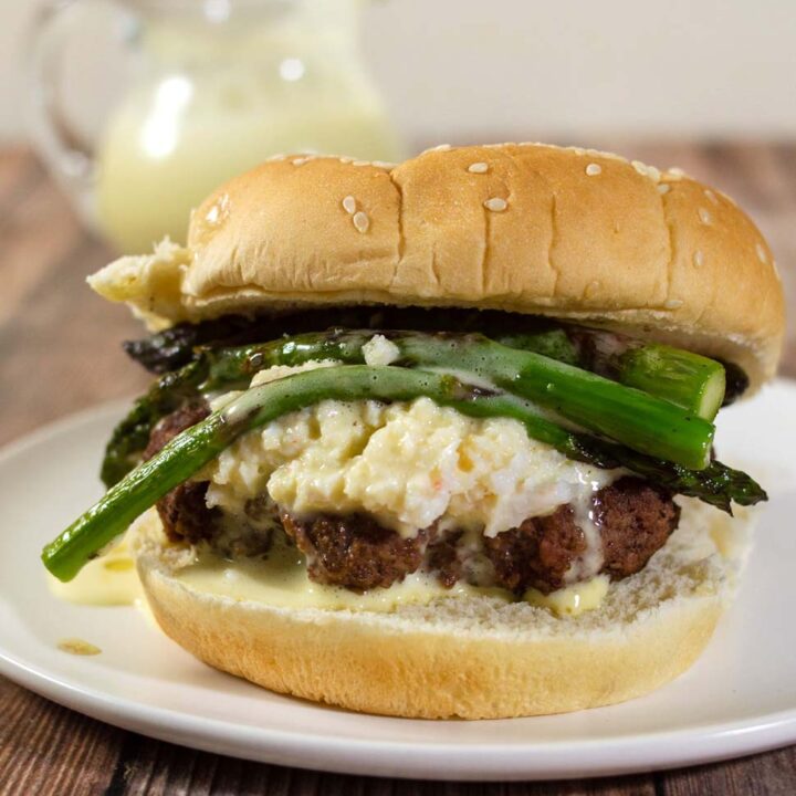 Surf-n-turf meets backyard cookout in these Oscar-Style Burgers. Hamburger patties are topped with crab meat, tender-crisp asparagus and rich Bearnaise sauce. #BurgerMonth