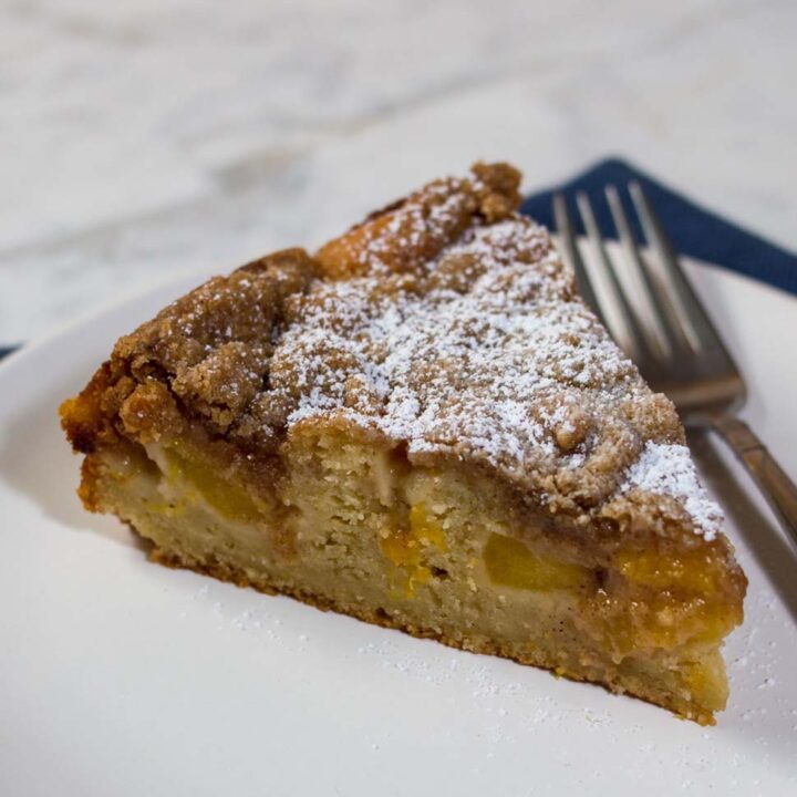 Peach brown butter coffee cake is loaded with peach slices and covered in cinnamon-spiced streusel crumbs. Enjoy it for brunch, dessert, or a snack any time of day!