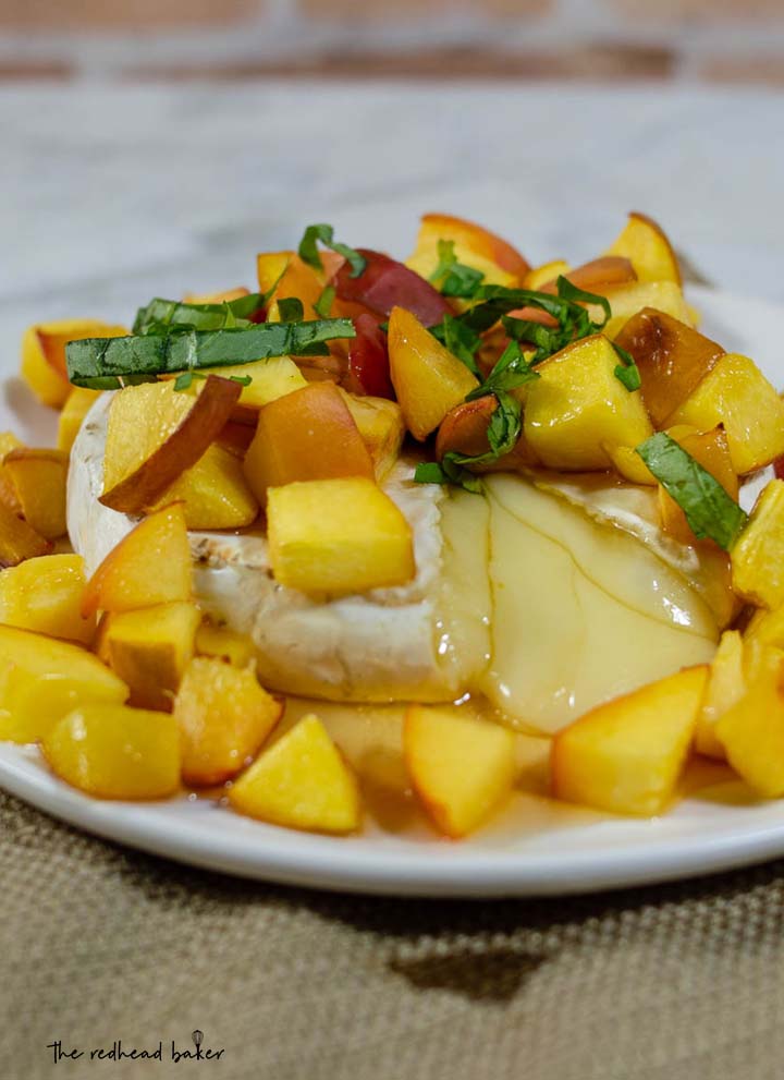 Think baked brie is only for winter holidays? Think again! Honey, basil and peach baked brie uses the freshest flavors of the summer to complement the buttery cheese. 