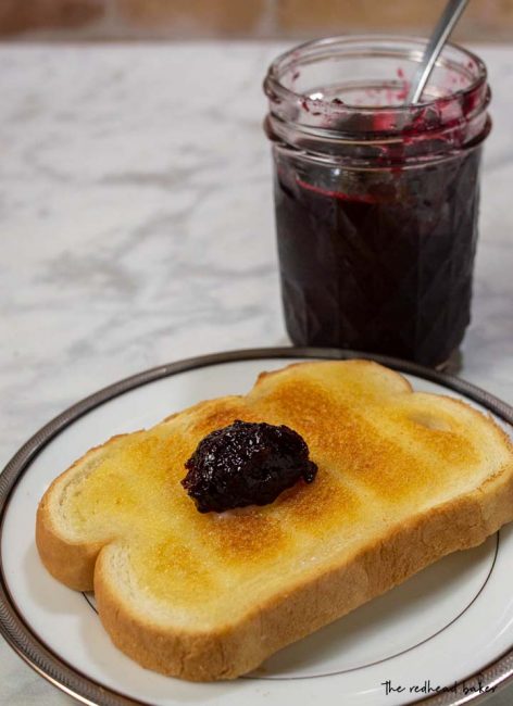 A buttered slice of toast with a dollop of cherry amaretto preserves