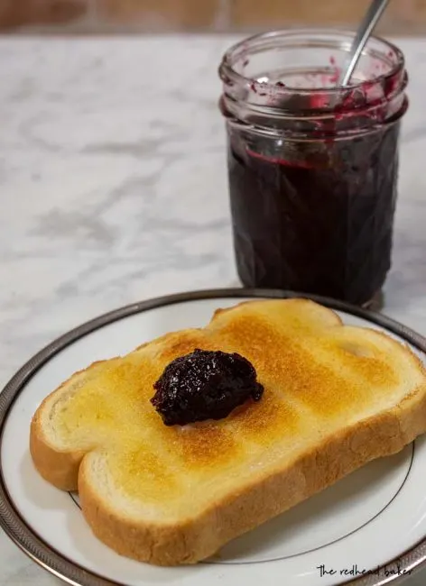 A buttered slice of toast with a dollop of cherry amaretto preserves
