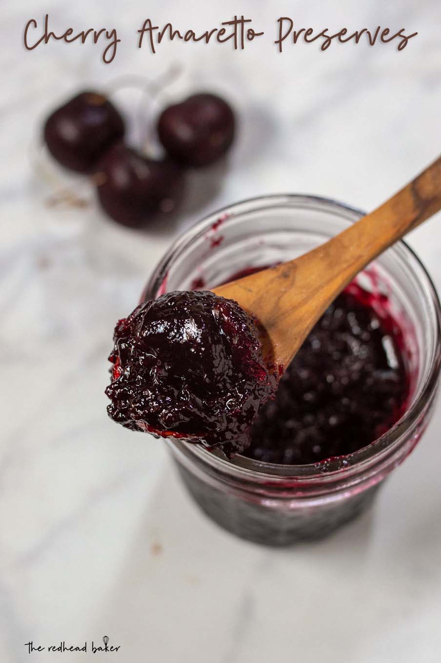 An overhead shot of a jar of cherry amaretto preserves