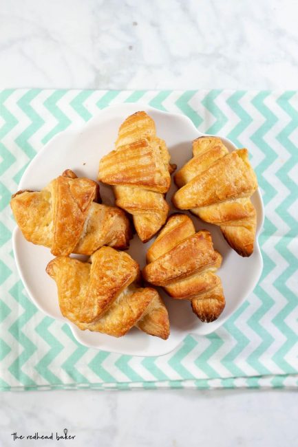 An overhead shot of a plate of mini butter croissants.