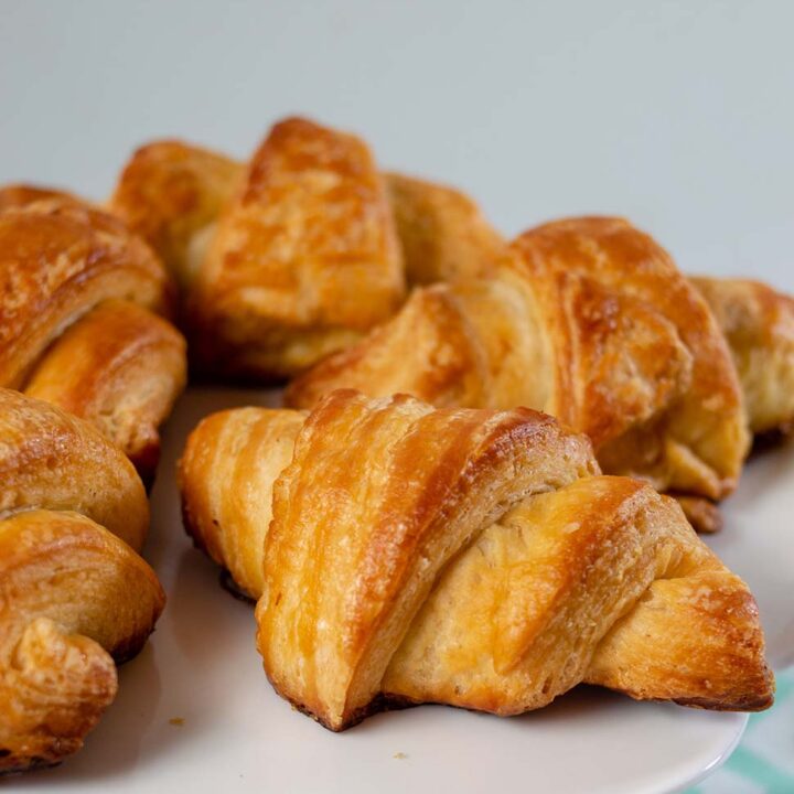 A close-up shot of a plate of mini butter croissants.