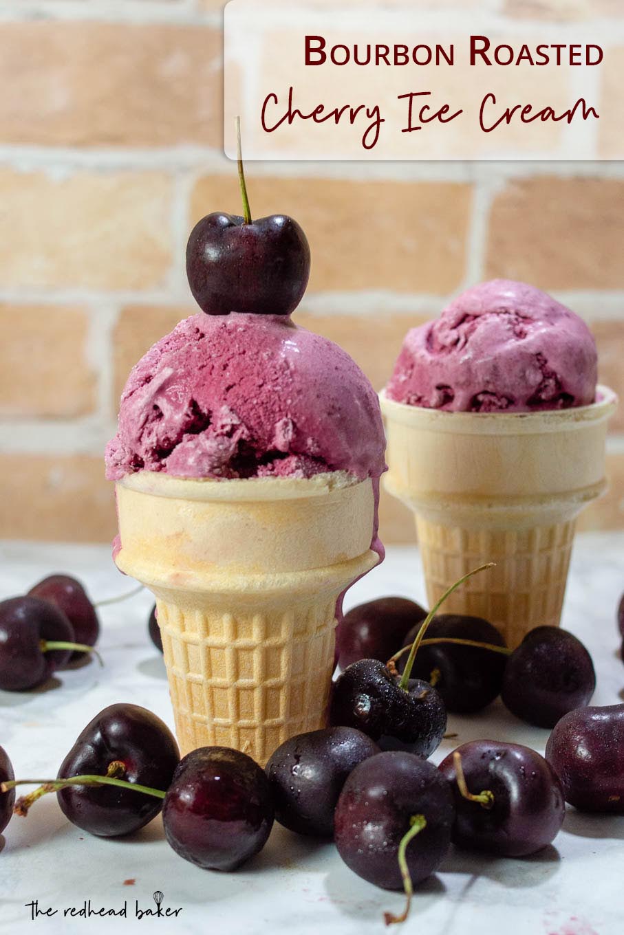 Two bourbon roasted cherry ice cream cones surrounded by fresh cherries