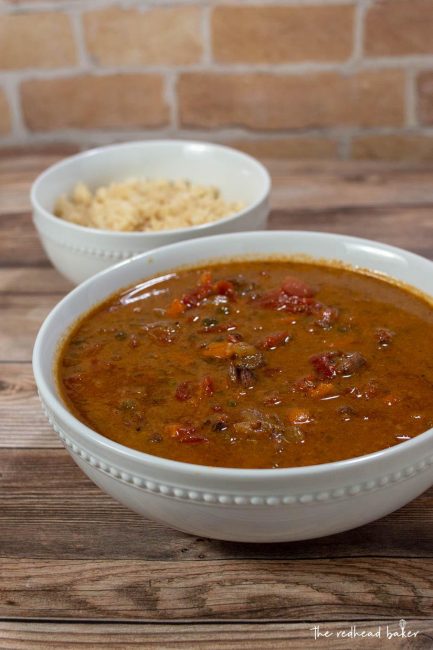 A bowl of ropa vieja in front of a dish of rice