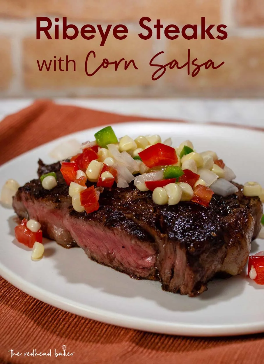 Half a ribeye steak topped with corn salsa.