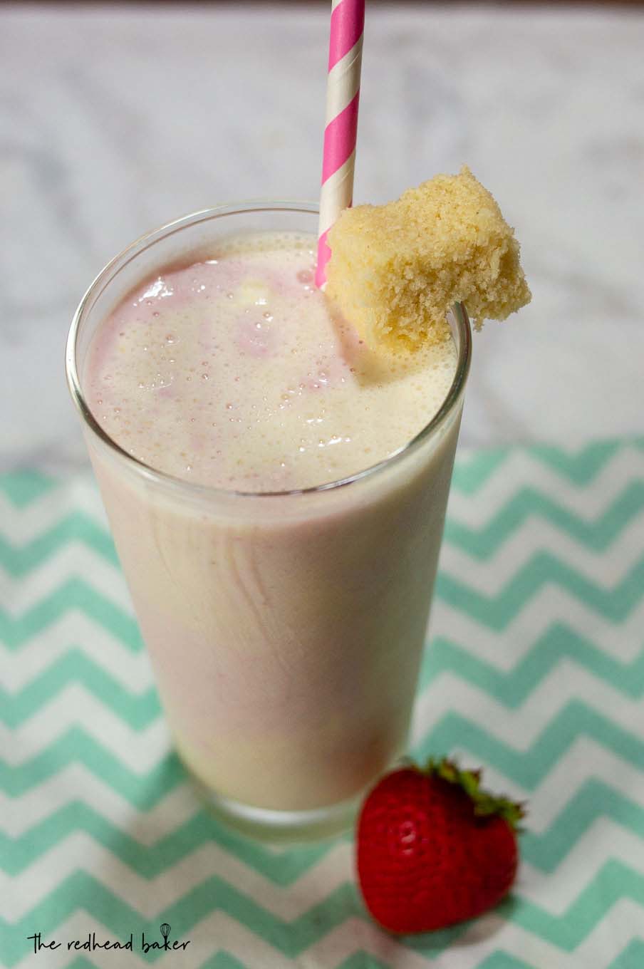 An overhead shot of an ungarnished strawberry shortcake milkshake