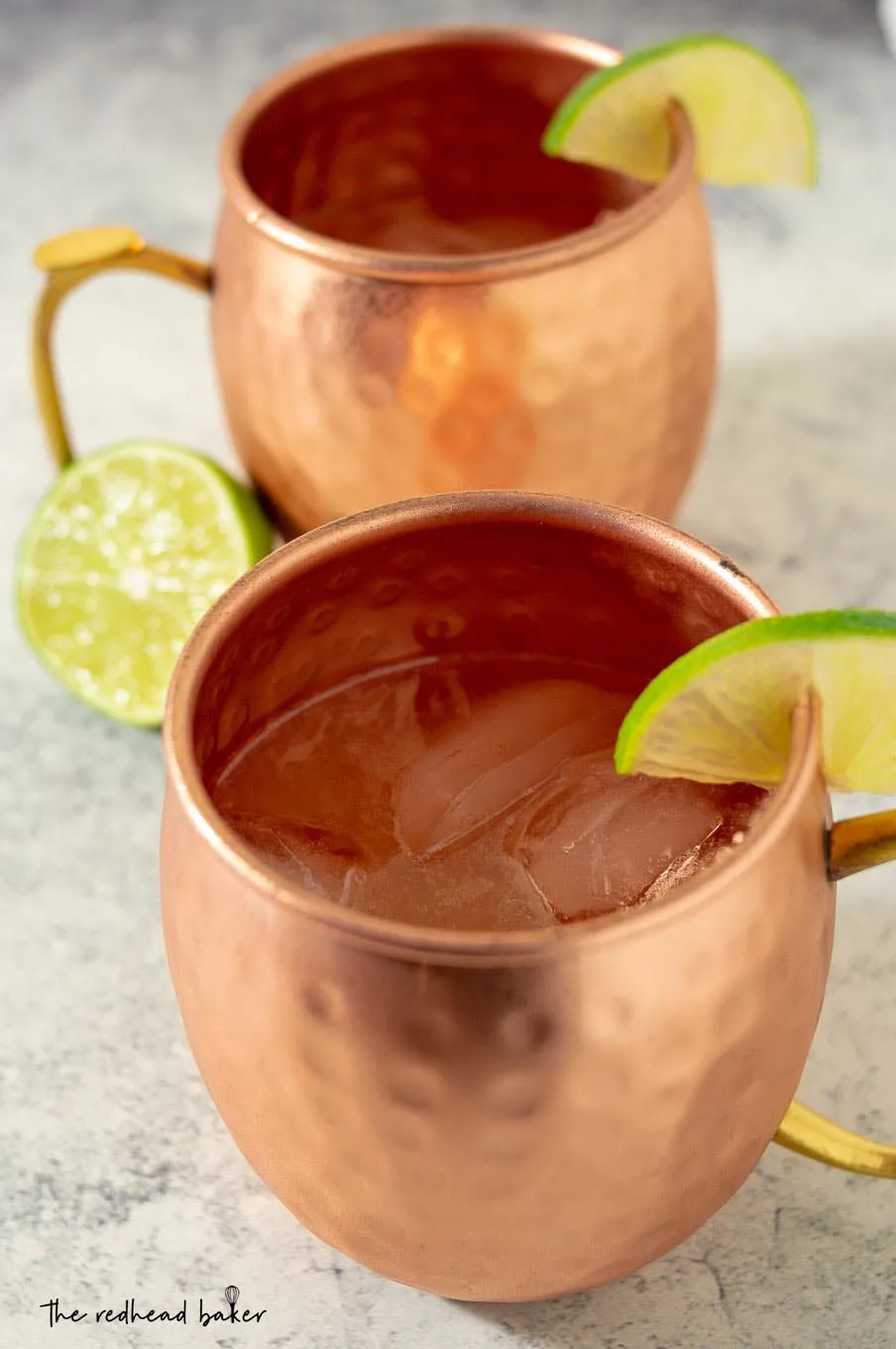 A high-angle shot of two mugs of Apple Cider Moscow Mules