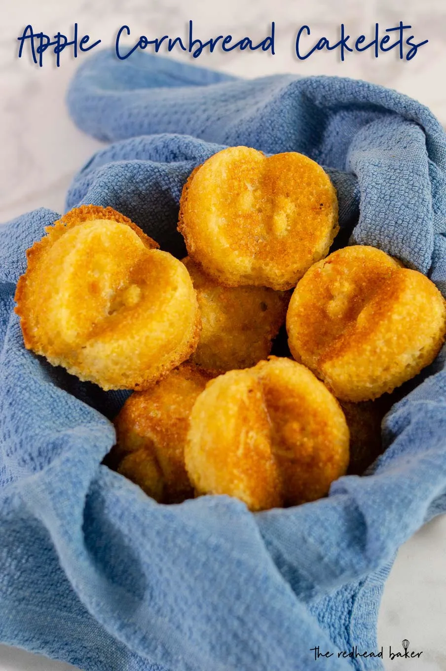 Apple cornbread cakelets in a blue-towel-lined basket