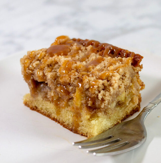 A close-up shot of a slice of caramel apple crumb cake