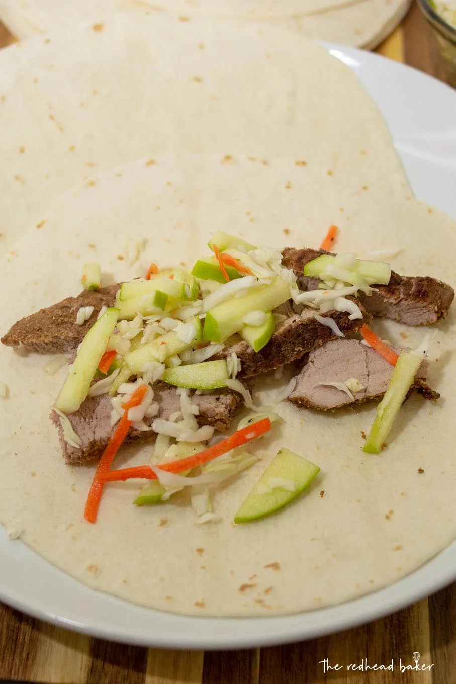 Pork taco with apple slaw on a plate