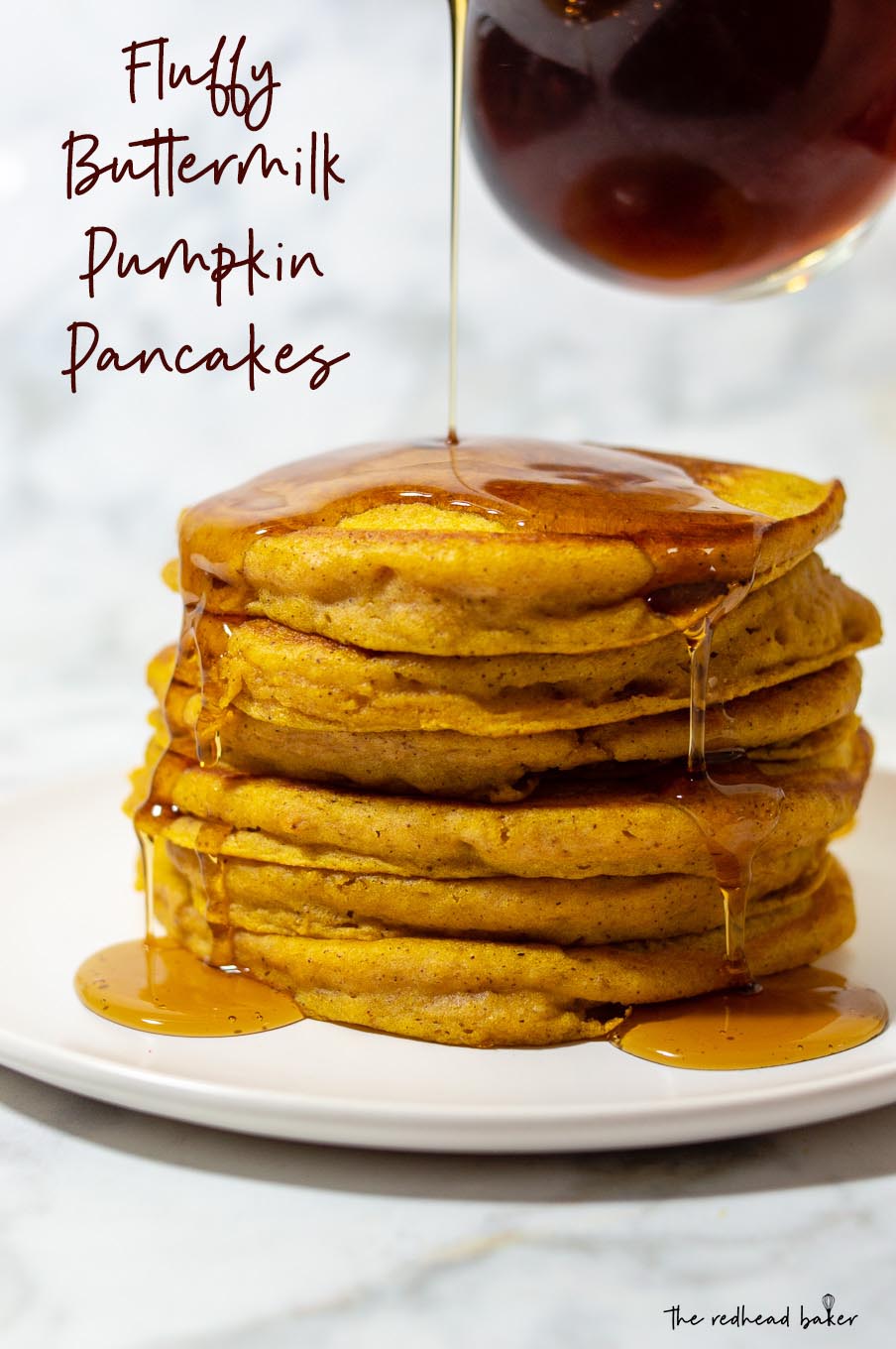 Maple syrup being poured onto a stack of pumpkin buttermilk pancakes