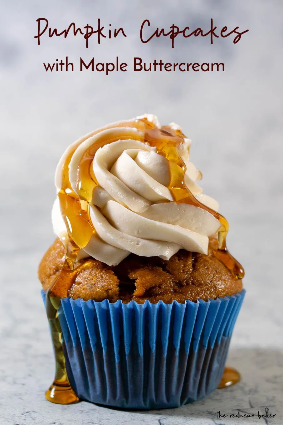 A close-up shot of a pumpkin cupcake with maple syrup dripping down the frosting