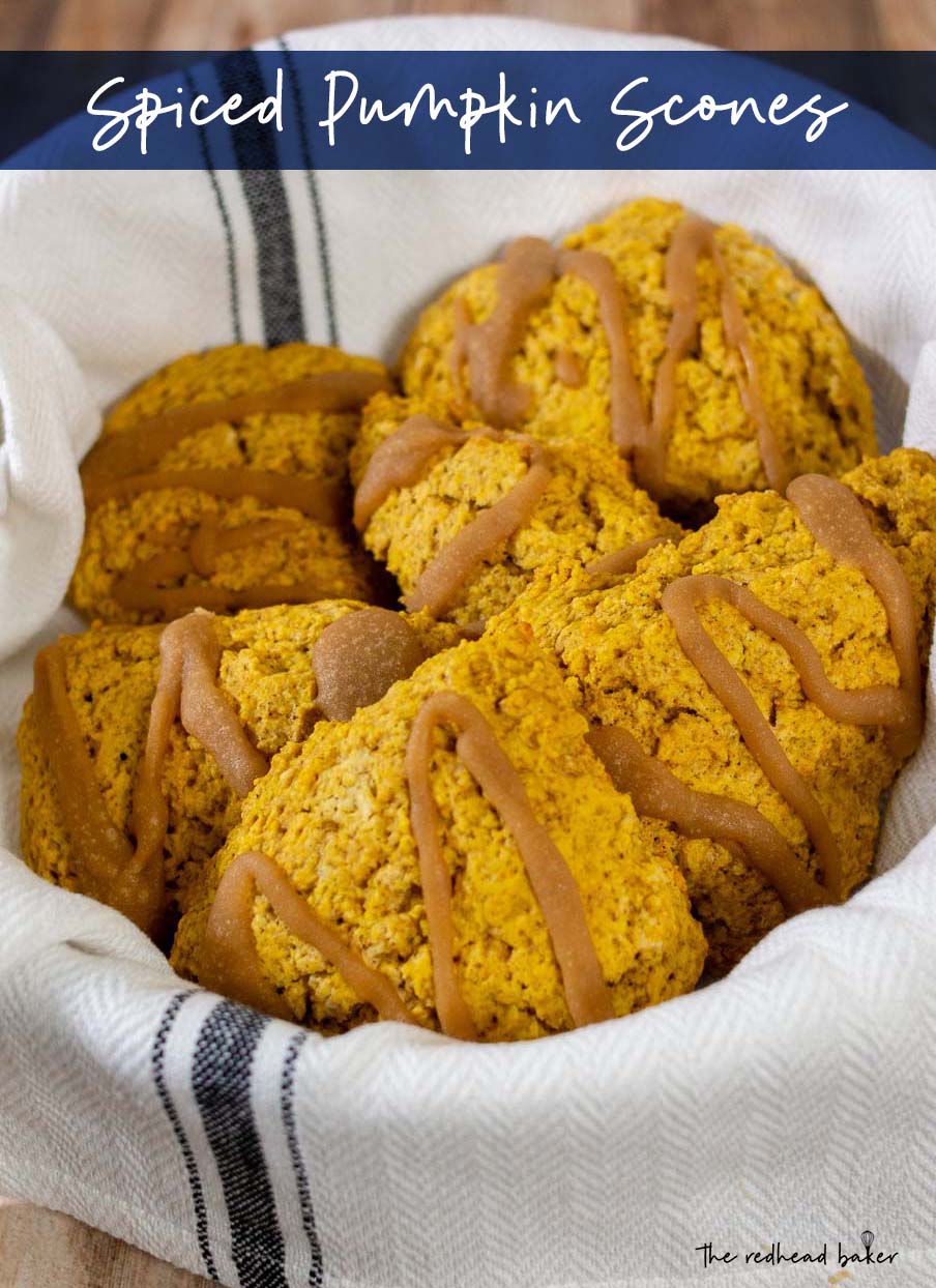 A white towel-lined basket holds a batch of spiced pumpkin scones.