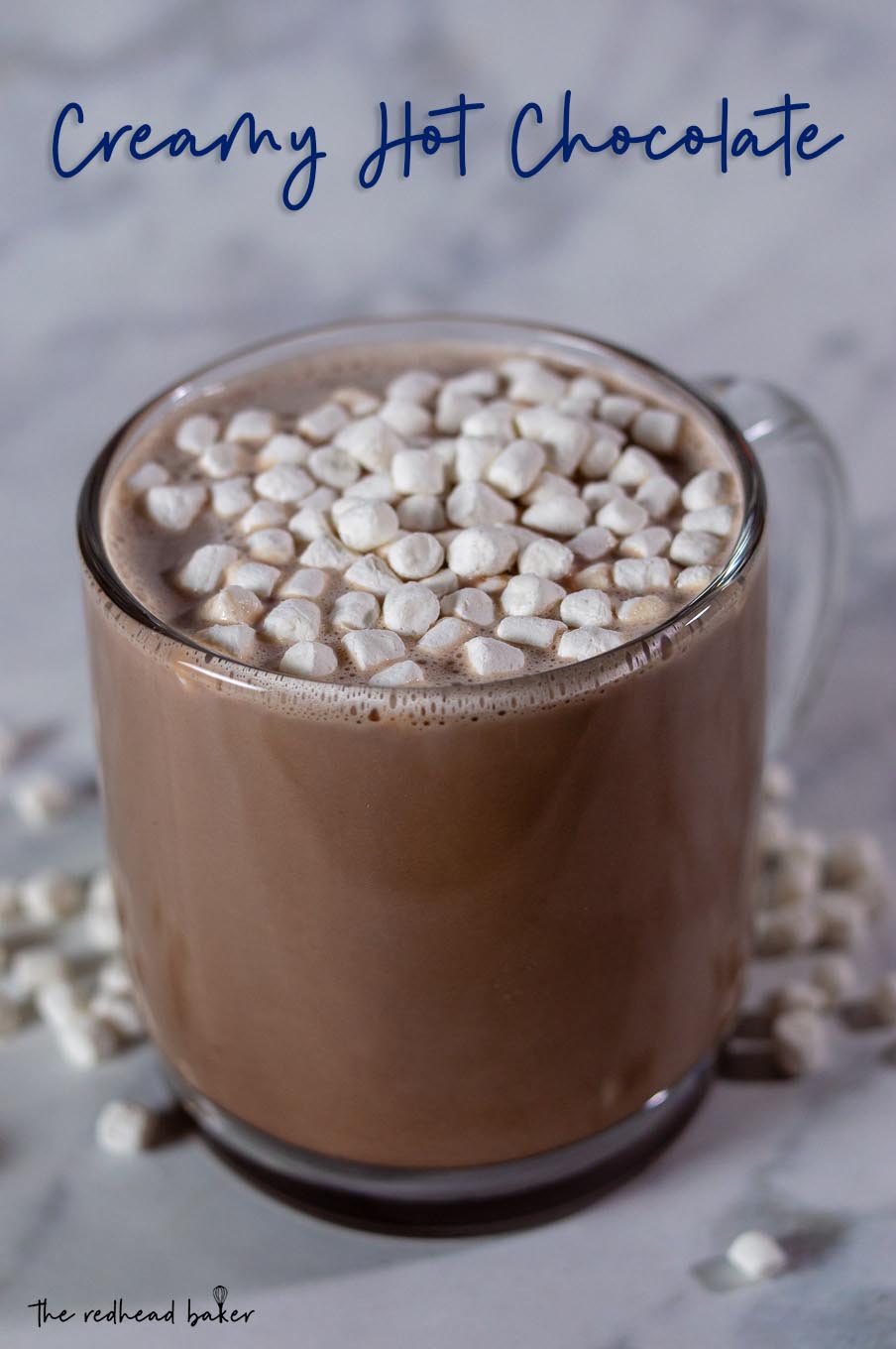 A mug of creamy hot chocolate topped with mini marshmallows