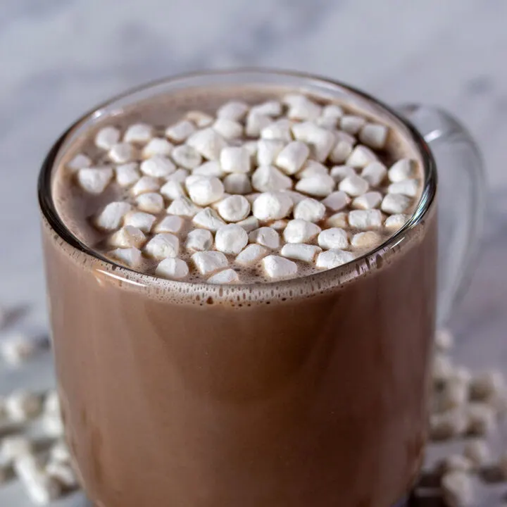 A mug of creamy hot chocolate topped with mini marshmallows