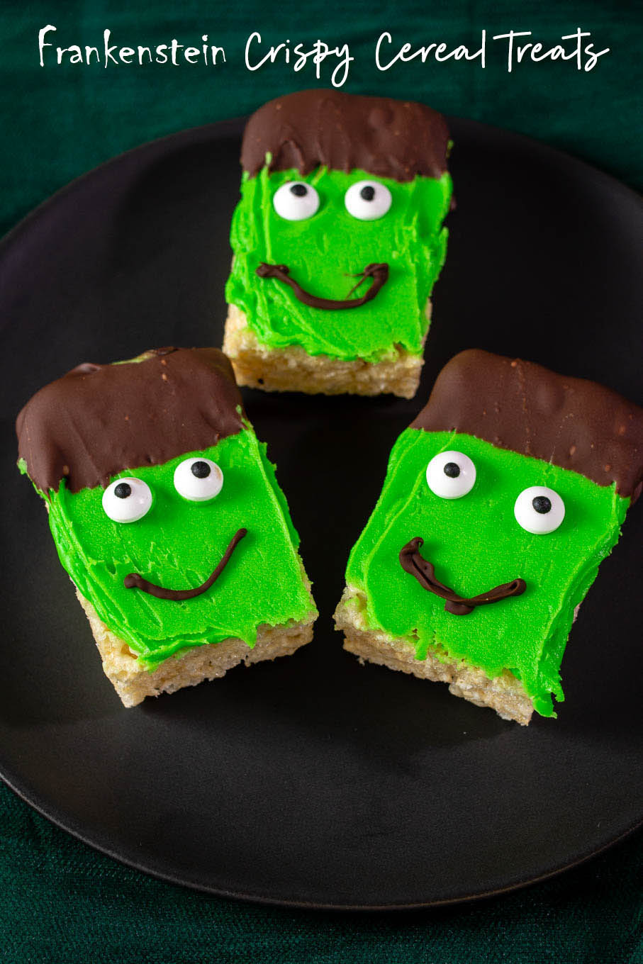 Three Frankenstein Crispy Rice Cereal Treats on a black plate