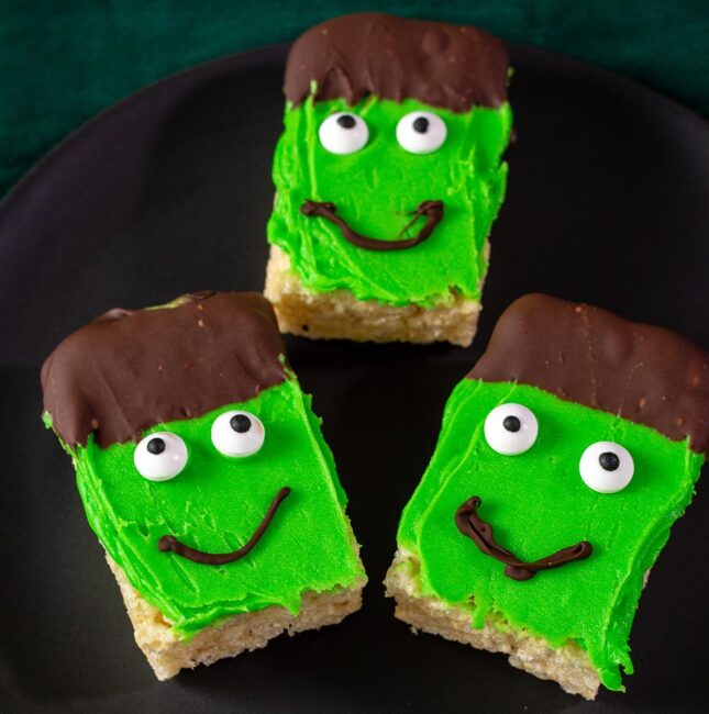 Three Frankenstein Crispy Cereal Treats on a black plate