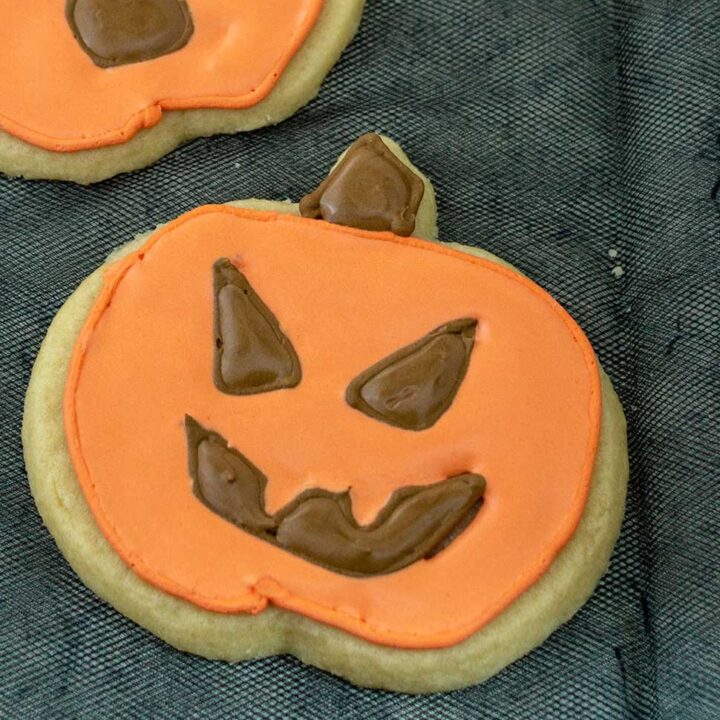 A close-up on a jack-o-lantern cookie