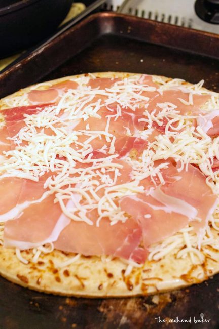 A white pizza with arugula before baking