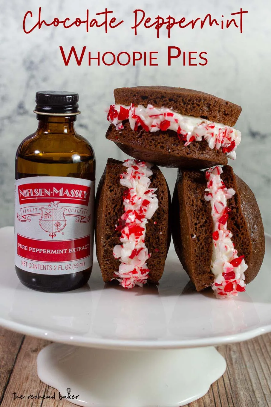 Three chocolate peppermint whoopie pies next to a bottle of Nielsen-Massey peppermint extract