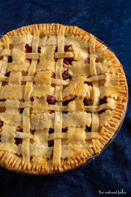 An overhead shot of a whole cranberry apple pie
