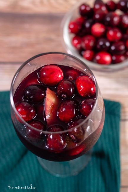 An overhead shot of a glass of cranberry apple sangria