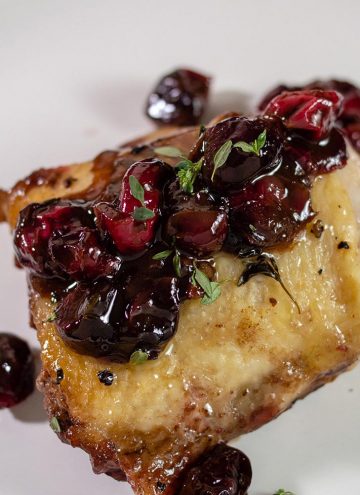 Cranberry balsamic chicken thighs on a plate