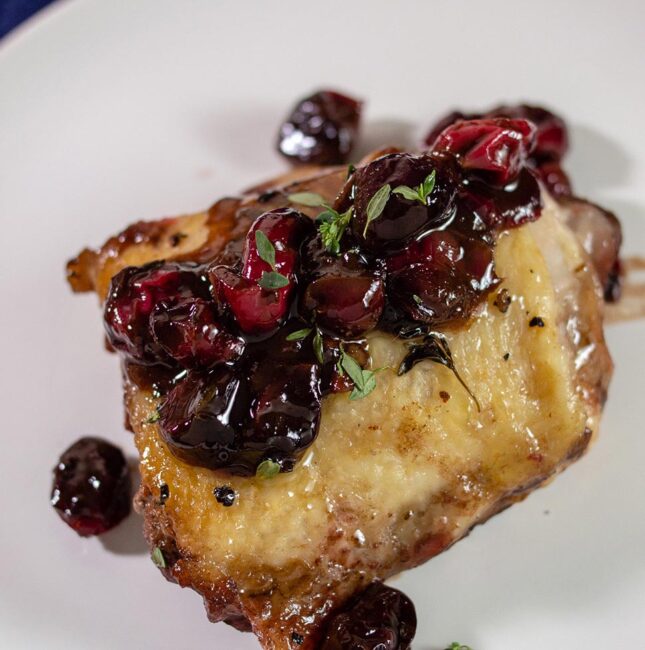 Cranberry balsamic chicken thighs on a plate