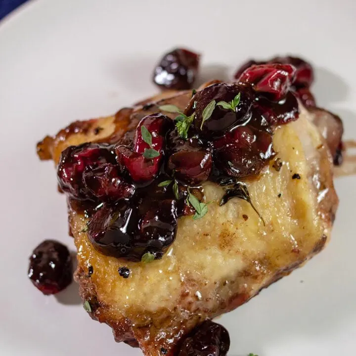 Cranberry balsamic chicken thighs on a plate