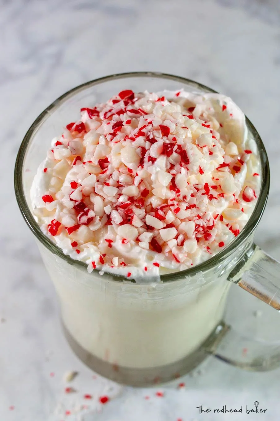 A candy cane crunch milkshake on a marble board