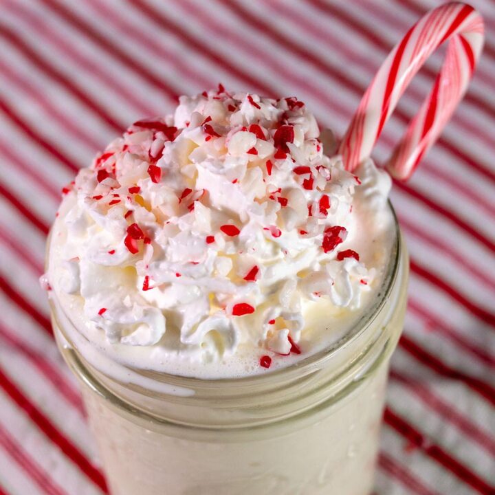 Close-up of a candy cane crunch milkshake garnished with a whole candy cane