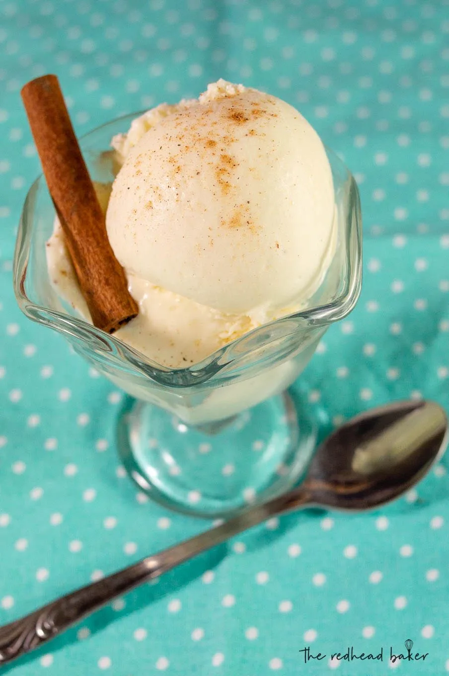 A dish of eggnog gelato with a cinnaon stick