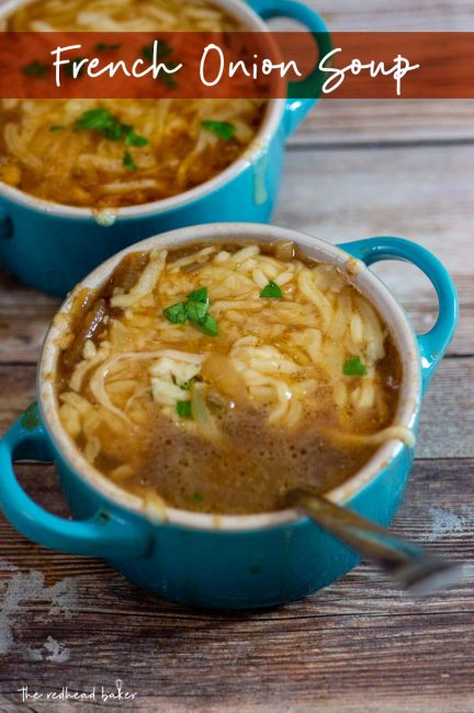 A close-up of two cocettes of French onion soup topped with chopped parsley