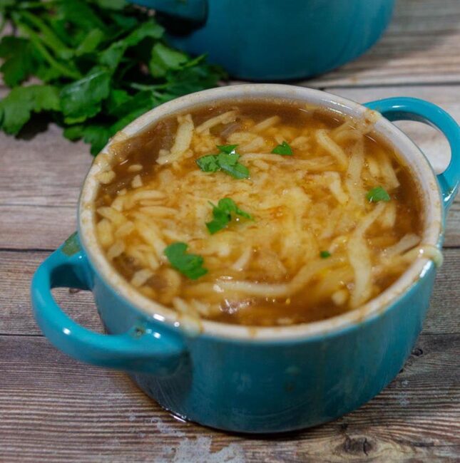 A close-up of a cocotte of French Onion Soup
