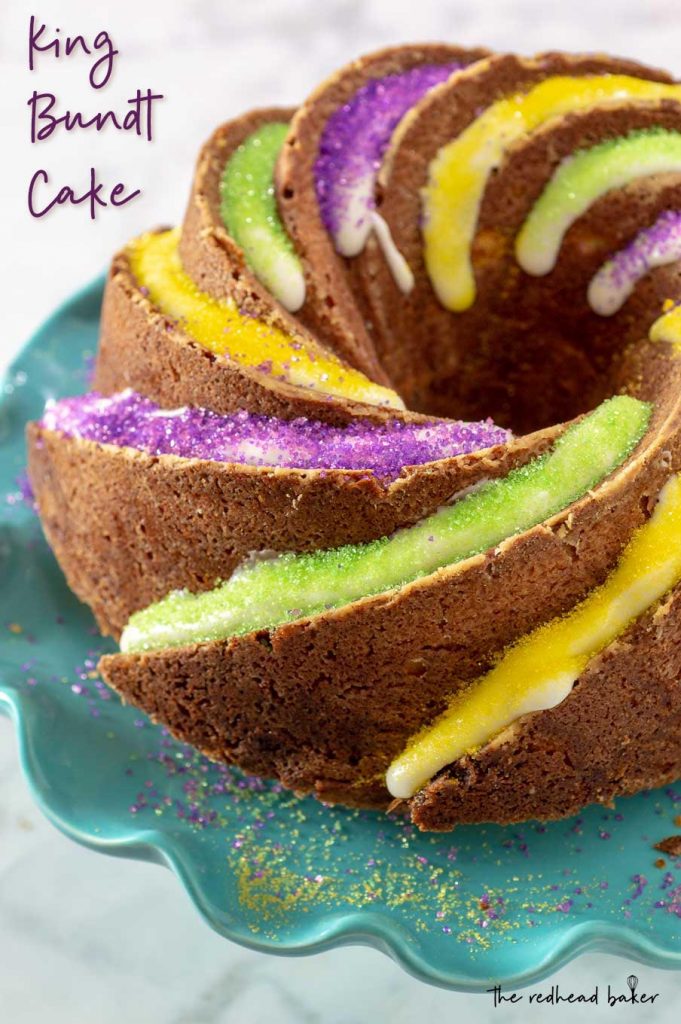 A frosted King Bundt Cake with alternating rows of purple, gold and green sugar sprinkles